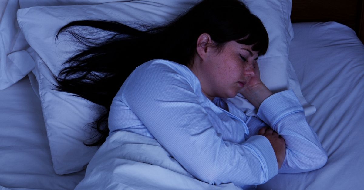 A woman sleeping at night.