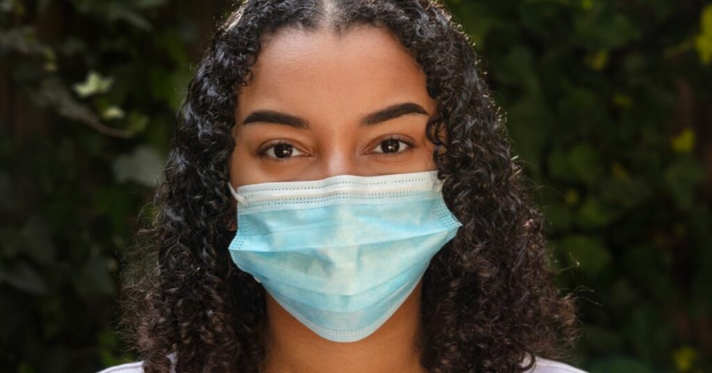 A woman wearing a face mask.