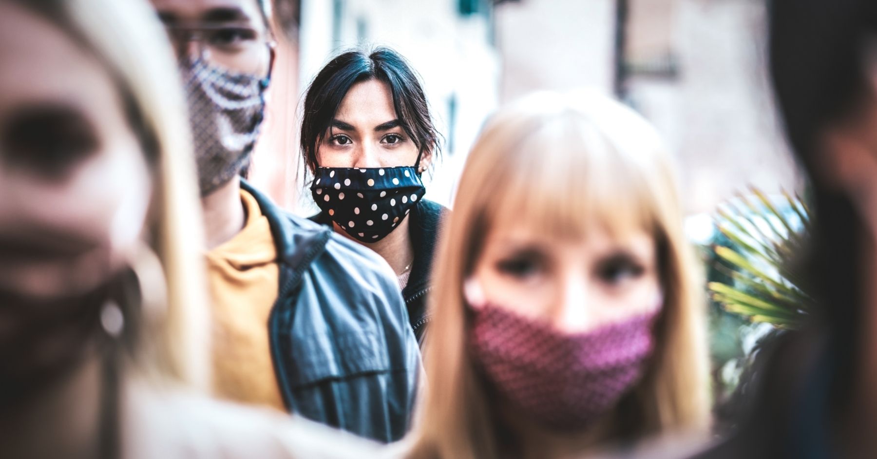 A crowd of people wearing masks.