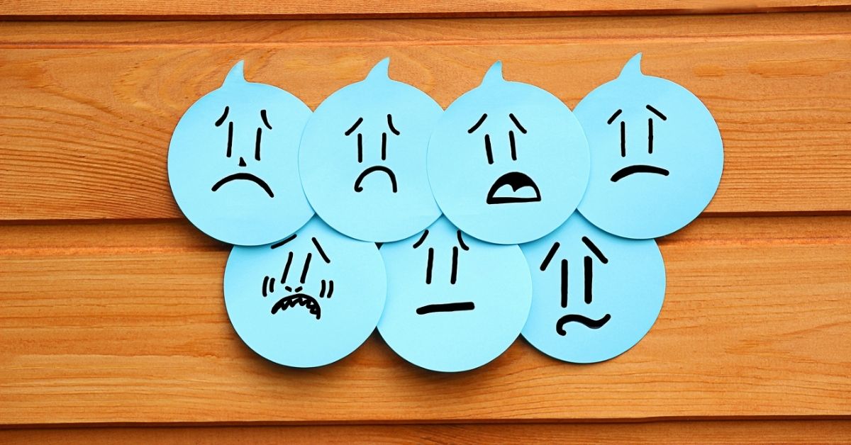 A negative emotion concept featuring facial expressions on speech bubbles.