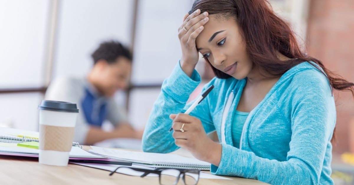 A college student studying and looking stressed.