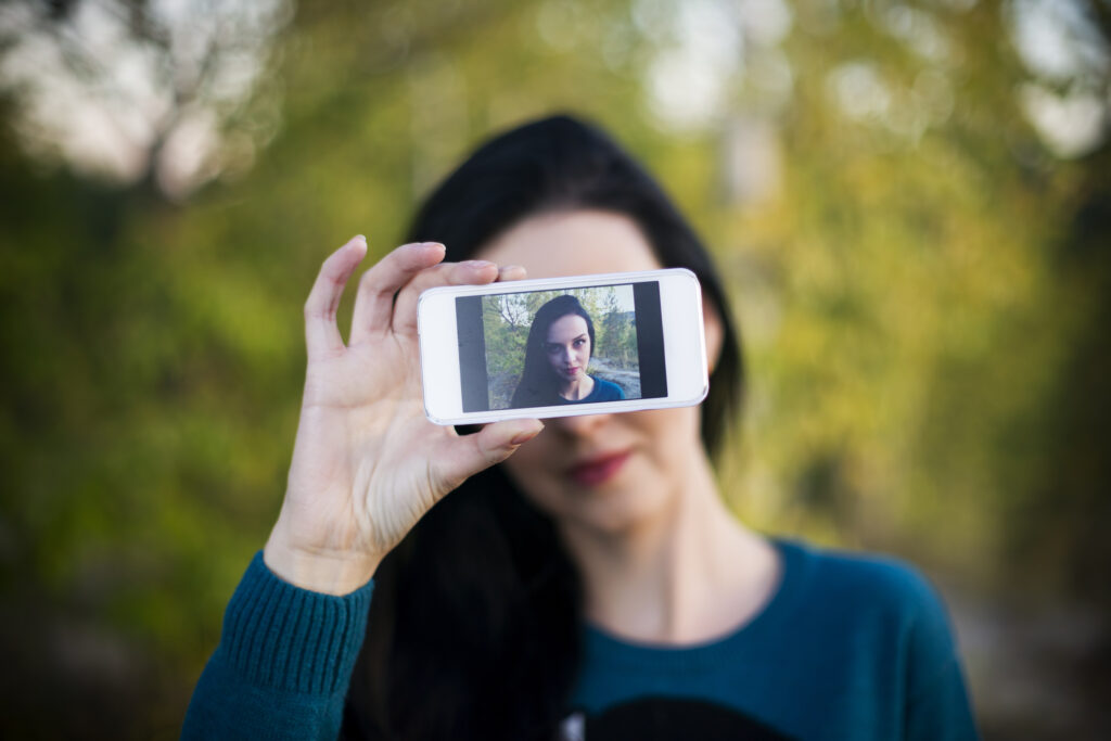 Woman taking selfie outdoors