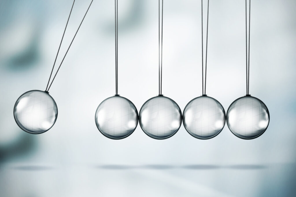 Newton's cradle on a soft gray background