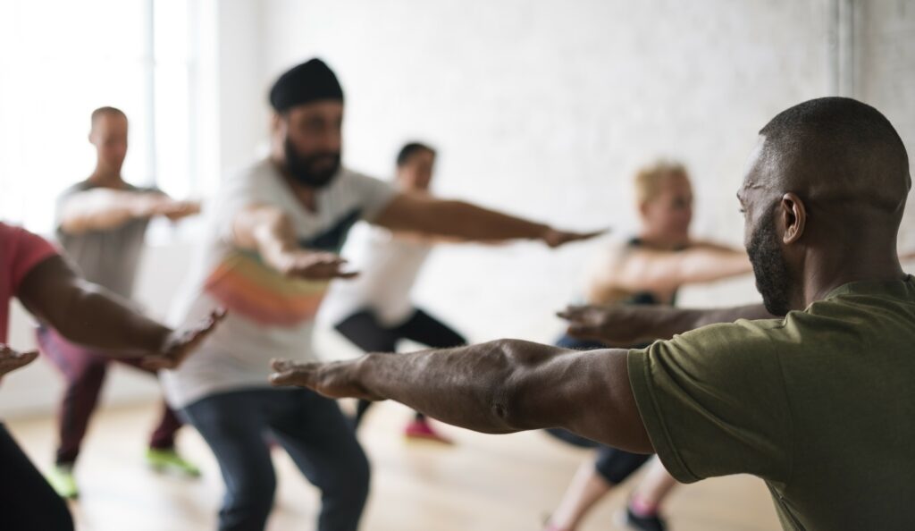 Image of a group of men in a yoga class