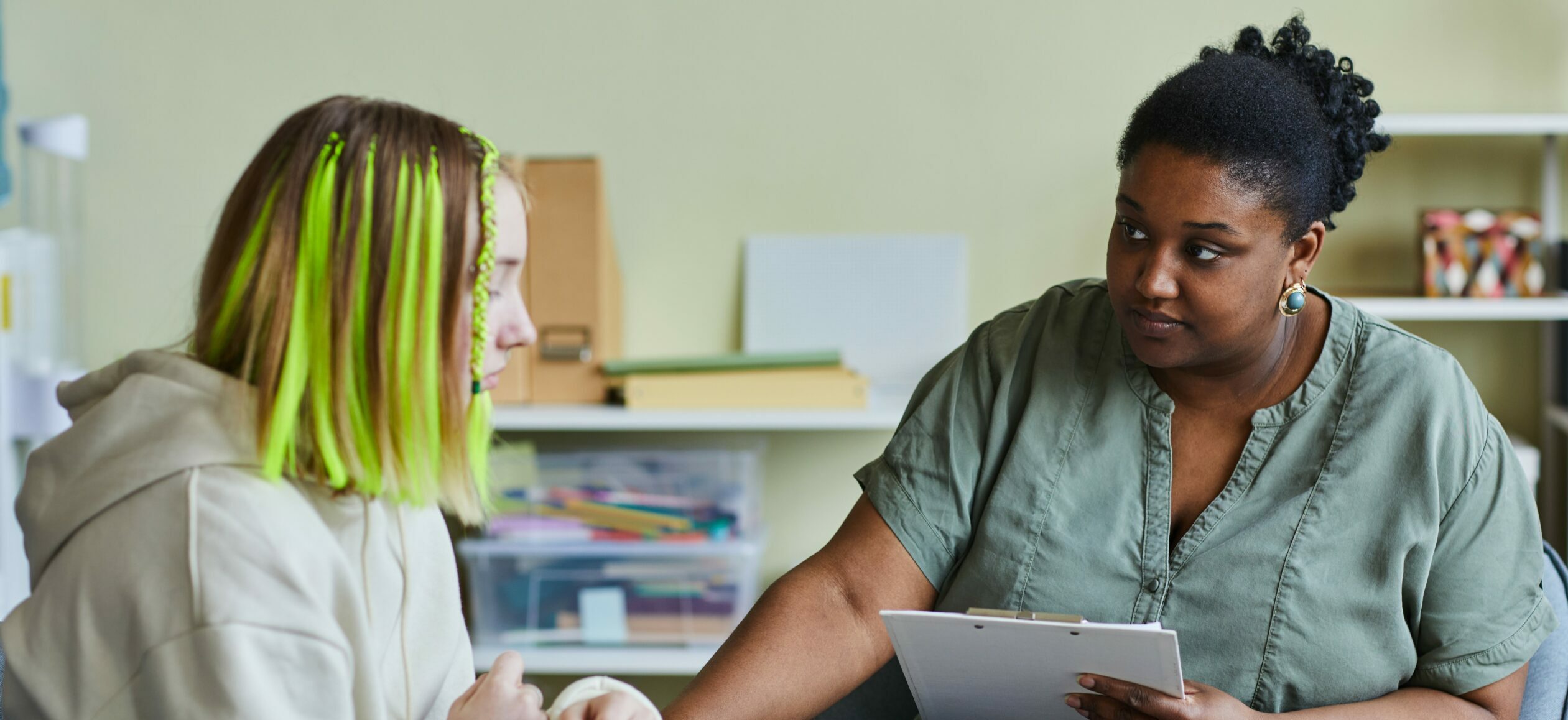A counselor and student sit and have a serious discussion