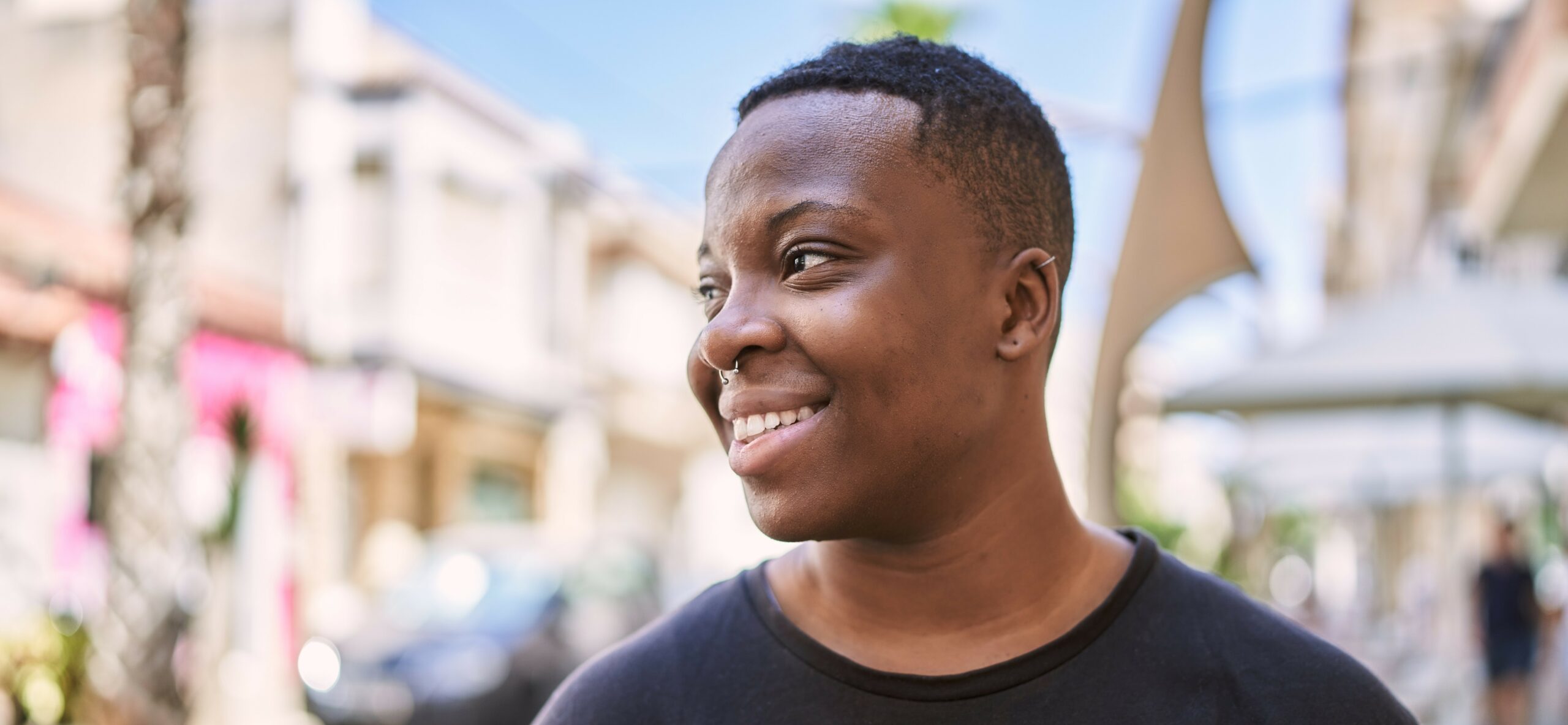 Close up image of a transgender person looking beyond the camera