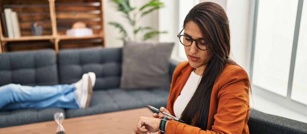A therapist checks her watch