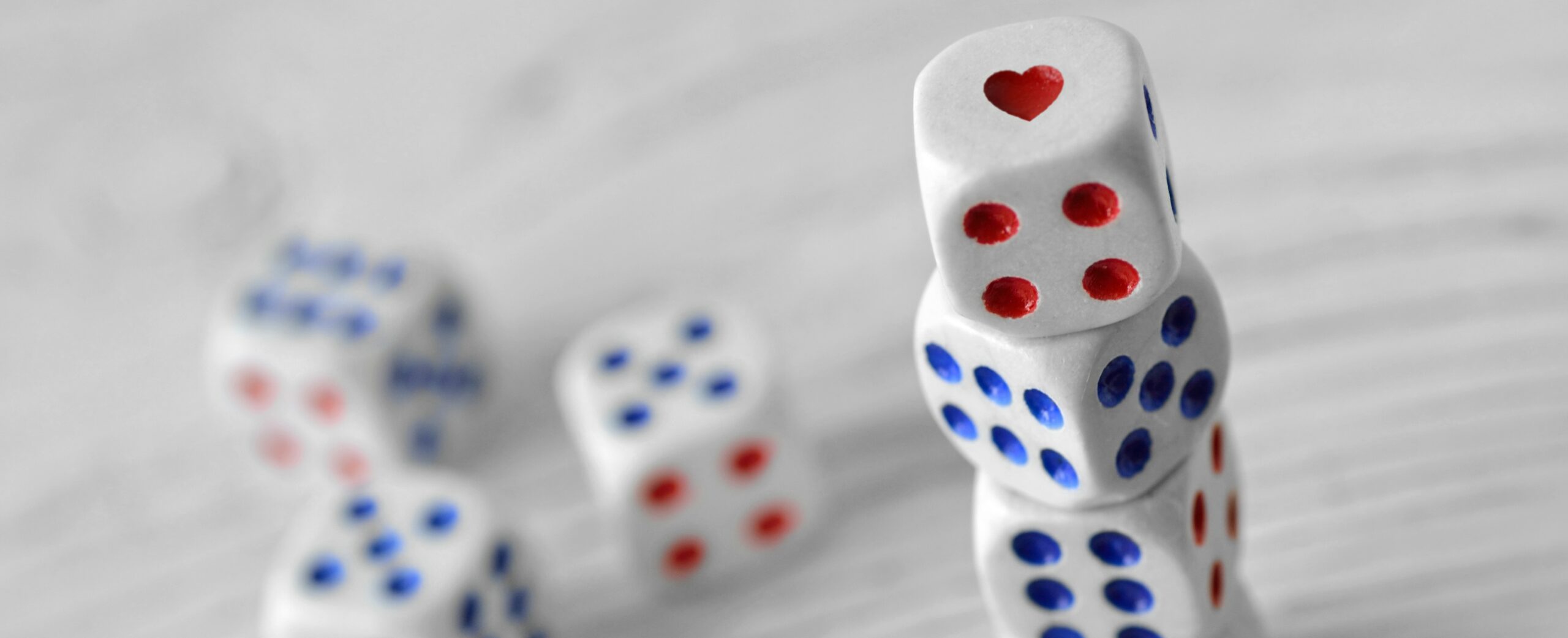 Stack of dice with one of the dots in the shape of a heart